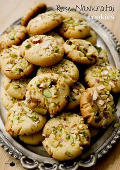 a plate full of cookies with nuts on top