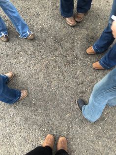 several people standing in a circle with their shoes on