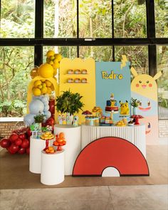 a table topped with lots of food and balloons