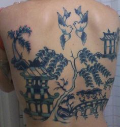 the back of a woman's body with tattoos on it