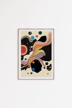 an abstract painting hangs on the wall in front of a white wall with a wooden frame