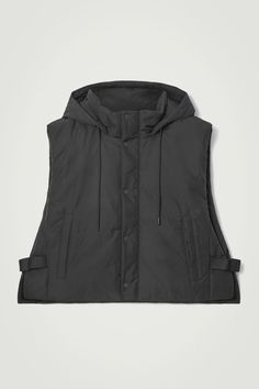 This season, we've created a mini capsule of hybrid pieces that are designed to be worn in a multitude of ways. Part of the edit, this padded vest is crafted from 100% recycled polyester and has practical features in abundance – note the drawstring hood, welt pockets and adjustable buckled tabs at the side. Layer it under a coat for extra warmth.  Regular fitZip closureA better alternative to conventional polyester, recycled polyester is made from pre‐ and post‐consumer waste Shell & Lining: 100% Recycled polyester / Machine wash Back length of size XS/S is 21.37", M/L: 21.96" Hooded Nylon Vest For Streetwear, Functional Hooded Nylon Vest, Functional Nylon Puffer Jacket, Hooded Nylon Vest For Outdoor Activities, Hooded Nylon Vest For Outdoor, Functional Hooded Outdoor Vest, Functional Nylon Vest Outerwear, Functional Nylon Puffer Jacket For Streetwear, Functional Puffer Vest For Streetwear