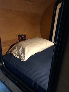 there is a small bed in the back of a truck with no sheets on it