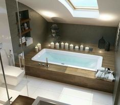 a bathroom with a large jacuzzi tub surrounded by candles