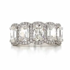 three stone ring with diamonds in the middle and two rows of stones on each side