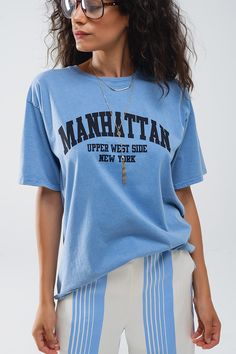 Introducing our Blue Relaxed T-Shirt With Manhattan Text– a statement piece that effortlessly combines comfort and style. Made in Italy, this oversized t-shirt features a relaxed fit and short sleeves, offering a laid-back yet chic look for everyday wear. The vintage black hue adds a touch of retro charm, while the graphic text proudly showcases "Manhattan Upper West Side New York."  This t-shirt, crafted with care in Italy, boasts a crew neckline for a classic touch. Its versatile design allows you to pair it effortlessly with jeans or skirts, creating a casual and stylish ensemble suitable for various occasions.  Made from 100% cotton, this t-shirt ensures a soft and comfortable feel against your skin, making it a go-to choice for all-day comfort. This shirt comes in size U, which means Urban Slogan Tops For Summer, Urban Style Slogan Tops For Summer, Summer College Style T-shirt With Graphic Print, Relaxed Short Sleeve T-shirt With Screen Print, Blue Slogan T-shirt For Summer, Urban Oversized T-shirt For Summer, Urban Style Oversized Summer T-shirt, Oversized Screen Print T-shirt For College, Relaxed Graphic Print T-shirt For Loungewear