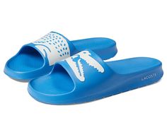 Lacoste Croco 2.0 222 1 CMA Slide - Men's Shoes : Light Blue/White : Lacoste brings you the comfy Croco2.0 222 2 CMA Slide Sandals, perfect to go with your poolside outfit. EVA upper. EVA lining and insole. Slip-on style. OrthoLite footbed. Signature brand detailing on the upper. EVA outsole. Imported. Casual Blue Sandals For Poolside, Casual Pool Slides For Spring, Casual White Pool Sandals, Casual Slip-on Flip Flops For Pool, Casual Slip-on Pool Flip Flops, Casual Synthetic Sandals For Pool, Casual Cushioned Sandals For Poolside, Casual Cushioned Flip Flops For Poolside, Casual Blue Slides For Swimming