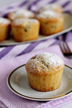 a muffin is on a plate next to other muffins