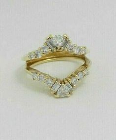 a gold ring with three diamonds on it