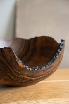 a wooden bowl sitting on top of a table