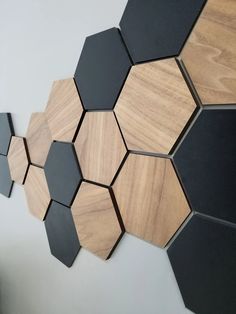 some black and brown hexagonals are on the wall next to a plant