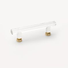 a glass and brass handle on a white background