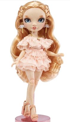 a doll with long blonde hair and blue eyes is standing on a pink base, wearing sandals