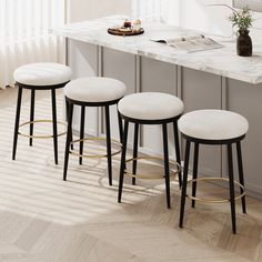 three stools sitting in front of a counter top