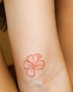 two women with tattoos on their legs and one has a flower tattoo on her arm