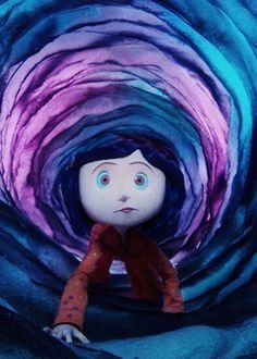 a doll sitting in the middle of a tunnel with blue and purple swirls on it