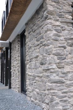 a stone building with black doors and windows