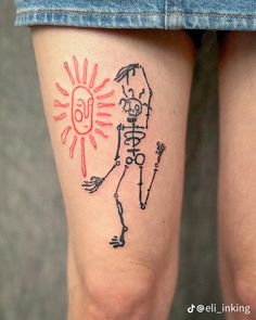 a person with a tattoo on their leg that has a skeleton and sun drawn on it