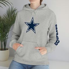 Show off your Dallas Cowboys Pride!!  This unisex heavy blend hooded sweatshirt is relaxation itself. Made with a thick blend of cotton and polyester, it feels plush, soft and warm, a perfect choice for any cold day. In the front, the spacious kangaroo pocket adds daily practicality while the hood's drawstring is the same color as the base sweater for extra style points. .: 50% cotton, 50% polyester .: Medium-heavy fabric (8.0 oz/yd² (271 g/m .: Classic fit .: Tear-away label .: Runs true to size Winter Fan Merchandise Cotton Hoodie, Winter Fan Gear Hoodie With Long Sleeves, Winter Fan Gear Hoodie, Cotton Long-sleeve Hoodie With Team Name, Winter Fan Apparel Hoodie, Winter Fan Merchandise Hoodie, Fleece Long Sleeve Fan Hoodie, Fleece Fan Apparel Hoodie With Long Sleeves, Casual Team Hoodie For Winter