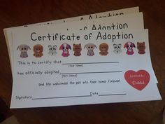 a person holding up a certificate with dogs on it and a heart in the middle