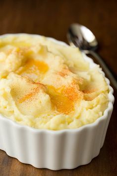 mashed potatoes in a white dish with cinnamon on top