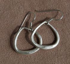 "Earrings-hoops-Hammered, Tapered Forged and milled Solid sterling wire shaped into a taper and then bent into this interesting triangle shape. I have a dull brush finish on these sterling silver earrings that measure 21mm or about 3/4' wide and with the ear wire they are 1 1/4\" long. Wonderful gift for mom who loves handmade classic jewelry. Simple Solid Sterling ... love these I can do these in larger sizes or in other metals, just contact me. Please read policies on returns and exchanges. An Modern Teardrop Hand Forged Hoop Earrings, Flower Earrings Gold, Minimalist Earring, Earrings Hoops, Jewelry Simple, Tiny Earrings, Earrings Hoop, Classic Jewelry, Wire Earrings