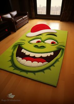 a green rug with a griny face on it in front of a large window