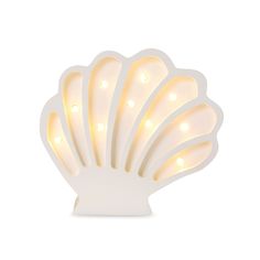 a white light that is shaped like a sea shell with lights on it's sides