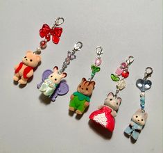 several keychains with various cartoon characters on them, all in different colors and shapes