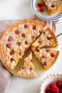 a pie with raspberries and almonds cut into slices