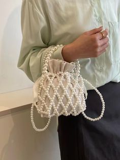 ✨ Our faux pearl handbag is the perfect blend of sophistication and style. Handcrafted with luxurious faux pearls, it boosts the glamour of any outfit. Whether you're heading to a formal event or a casual outing, our bag is for you! ✨ 👜 Our handbag is ideal for those needing a stylish way of carrying their personal items. Not only will it make carrying your personal items easy, but it will elevate any outfit! 👜 💟 We craft our bags to uphold the finest standard of quality. Our faux pearls prov Elegant Cream Pouch Bucket Bag, Elegant White Bucket Bag For Evening, Elegant White Evening Bucket Bag, Elegant White Bucket Bag With Pearl Handle, Elegant Beige Bucket Bag For Party, Elegant Wedding Bucket Bag, Elegant Tote Evening Bag With Pearl Handle, Elegant Evening Tote Bag With Pearl Handle, Elegant Bucket Bag For Events