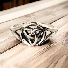 "Handcast 925 Sterling Silver Irish Celtic Filigree Trinity/Triquetra Knot Ring     The Triquetra originally meant \"triangle\" and was used to refer to various three-cornered shapes. The design is used as a religious symbol adapted from ancient Celtic images by Christianity. It is similar to Odin's symbol, the valknut.                                        This gorgeous ring was handcast by me in my studio from solid stamped nickle free 925 Sterling Silver. The ring measures approx. 0.39\" tall, tapering down to 0.1\" in back Weight approx. 3-5 grams depending on ring size. The ring can be custom sized from size 5 up to size 10 for no additional charge. Jewelry Gift Box Handling time approx. 5 days Domestic Standard shipping $4 Domestic Priority Mail shipping $8 Domestic Express Mail shi Triquetra Design, The Triquetra, Triquetra Jewelry, Odin Symbol, Celtic Images, Adjustable Silver Viking Ring, Tree Of Life Ring, Religious Symbols, Irish Celtic