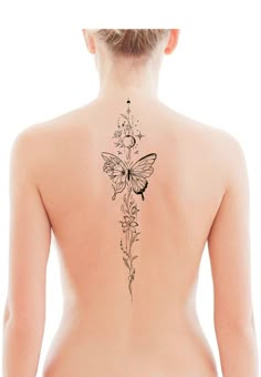 a woman's back with a butterfly tattoo on her left side and flowers in the middle