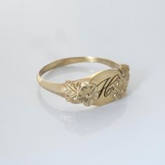 This vintage-inspired floral ring is a series of dainty flowers wrapped around your fingers. Handmade and polished, it is available in 14K gold. This item is engravable with text or monogram of your choice at no extra cost. The initals are engraved onto the ring and embedded in the 3D model for a flawless embossed finish. You may also request for writing on the inside! You may choose to customize this ring with different flowers or letters. Depending on the text used, the flowers may be rearrang Elegant Engraved Open Flower Ring, Vintage Adjustable Initial Ring Personalized, Oval Flower Ring For Wedding, Vintage Rose Gold Jewelry With Flower Charm, Vintage Adjustable Personalized Initial Ring, Heirloom Birth Flower Jewelry, Adjustable Rose Gold Signet Ring For Wedding, Wedding Ring Jewelry With Flower Charm, Vintage Engraved Open Ring For Promise