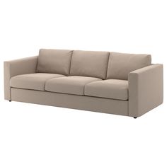 a beige couch sitting on top of a white floor