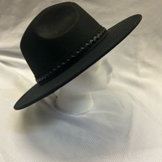 Brand New, Never Been Used. Black Hat Decorated With Woven Leather Strapping. Adjustable Strings Inside For The Perfect Fit. Black Fall Hats One Size, Black Fedora Felt Hat One Size Fits Most, Black Hat Band For Spring, Chic Black Fedora With Curved Brim, Black Hats For Fall, Black One Size Hats For Fall, Adjustable Black Hat Band For Spring, Adjustable Black Hat Bands For Spring, Trendy Black Fedora Felt Hat