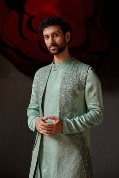 Smokey Pallid Shrug Set | Jatin Malik Introducing our best-seller in chateau grey, now reimagined in a stunning paneled shrug. This elegant piece is hand-embroidered using two distinct zardozi techniques, featuring intricate resham and gold work for a rich, textured finish. Paired with a matching tone-on-tone drape kurta and tapered trousers, this ensemble exudes sophistication and refined style. Perfect for making a statement at any special occasion, this outfit showcases the finest craftsmanship and timeless elegance. Included in purchase: Shrug Set, Kurta, Trousers Product Specification Color: Chateau Grey Fabric: Linen Silk Occasion: Engagement, Wedding, Bridal, Reception Style: Shrug Set, Kurta, Trousers Care: Dry Clean Work: Hand Embroidery Customization options:Can be customized in Jatin Malik, Blouse Yoke, Haldi Outfit, Kurta Men, Wedding Outfit Men, Dhoti Pants, Indian Groom, Royal Look, Haldi Ceremony