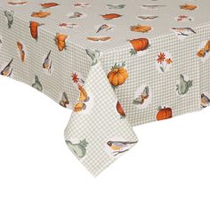 a table cloth with birds and pumpkins on it, sitting on top of a white table