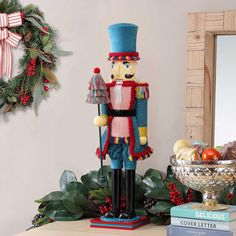 a nutcracker statue sitting on top of a table next to a bowl of fruit