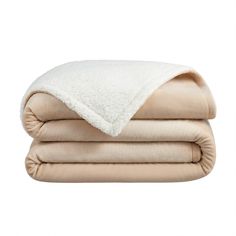 two blankets folded on top of each other, one with a white and beige blanket