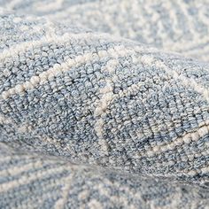 a close up view of a gray and white blanket