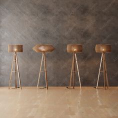 three wooden floor lamps in an empty room