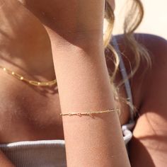 One of our favorite chains - now offered as a bracelet! The Dot + Dash Bracelet stands out for its bar link chain making it minimal but still incredibly notable! DETAILSAvailable in 14k Gold Fill and Sterling SilverHypoallergenic, Nickel Free and Water Safe MEASUREMENTSXS is 5.5" longS is 6" long M is 6.5" longL is 7" long XL is 7.5" long To measure your bracelet size, wrap a piece of string around your wrist the way you would like the bracelet to fit. Then lay the string flat and measure the in Minimalist 14k Gold Charm Bracelet With Delicate Chain, Minimalist 14k Gold Name Bracelet With Adjustable Chain, Minimalist 14k Gold Charm Bracelet With Adjustable Chain, Dainty 14k Gold Name Bracelet With Adjustable Chain, 14k Gold Chain Bracelet With Satellite Chain, Everyday 14k Gold Satellite Chain Bracelet, Minimalist 14k Gold Satellite Chain Bracelet, Dainty Link Charm Bracelet With Delicate Chain, Dainty Charm Bracelet With Delicate Chain