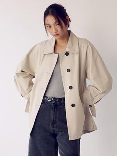 This is a belted trench coat with a three-dimensional silhouette. The voluminous raglan sleeves provide a casual yet feminine atmosphere, and the belt detail allows for a slimmer silhouette. It is an essential item that has a casual yet feminine vibe and can be worn with a variety of outfits.- Made of high-density cotton material with a luxurious appearance and soft feel.- Pockets on both sides for practical use- Open and close using buttons that match the design- Tuck on the back creates a voluminous silhouette*The color of the product may differ from the actual color depending on the monitor resolution. Classic Oversized Outerwear With Belted Cuffs, Modern Belted Spring Outerwear, Oversized Chic Outerwear With Belted Cuffs, Chic Oversized Outerwear With Belted Cuffs, Chic Oversized Belted Outerwear, Chic Outerwear With Belted Cuffs For Daywear, Chic Daywear Outerwear With Belted Cuffs, Oversized Outerwear With Belted Cuffs For Spring, Trendy Beige Belted Outerwear