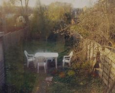 an outdoor table and chairs in a back yard