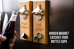 a person holding a beer bottle in front of two wooden magnets that say hidden magnet catches your bottle caps