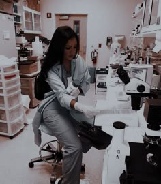 a woman sitting on top of a chair in a lab