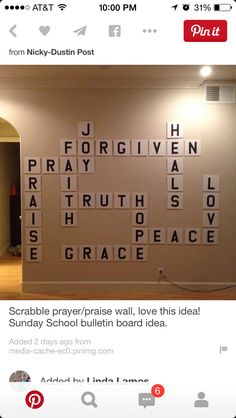 a wall that has some type of words on it in the middle of a room