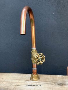 a copper colored faucet on top of a wooden table