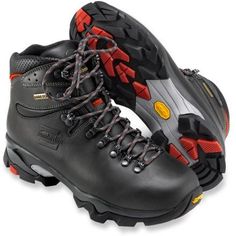 a pair of black hiking boots with red laces on the outstretches